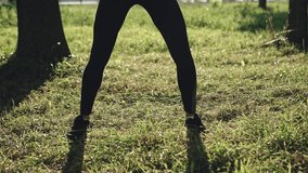 Young woman in sportswear exercising in park on sunny day
