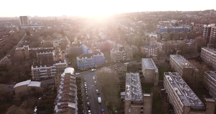 Aerial drone footage of residential buildings in the North of London, England: Finsbury Park/Crouch Hill area.  Sun is low on the horizon.