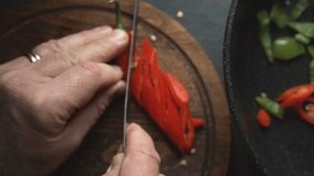 Man cuts chili for fajita close-up. Mexican food video