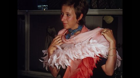 PARIS, 1970, Archival, Young shop women modeling feather boa, scarf, at Christian Dior, Pairs