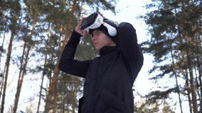 young man dresses virtual reality glasses