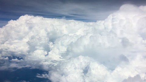 Huge clouds from aircraft window. Top on Indian ocean. 