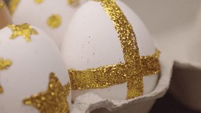 panned shoot closeup of easter egg in golden glitter