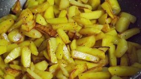 Bow falling on fried potatoes in a frying pan in slow motion - Powered by Shutterstock - Get 15% off with code: PIKWIZARD15