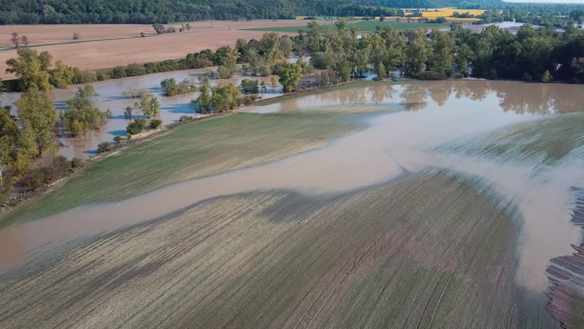 Top aerial view of muddy flood river flow in forest