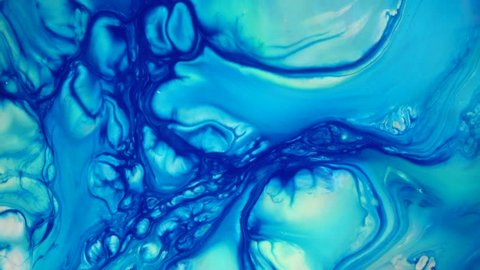 4K footage. Ink in water. Blue ink reacting in water creating abstract background.