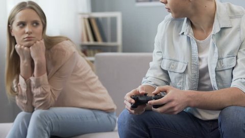 Man gamer teaching his girlfriend playing space shooter video game Stock  Photo by ©DragosCondreaW 465086788