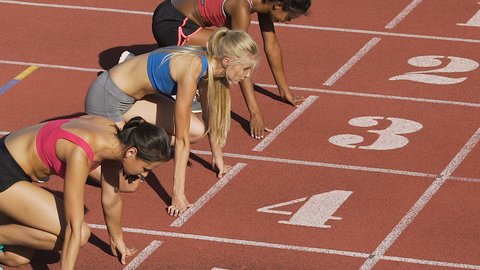 Three female athletes simultaneously start running marathon, rivalry, slow-mo