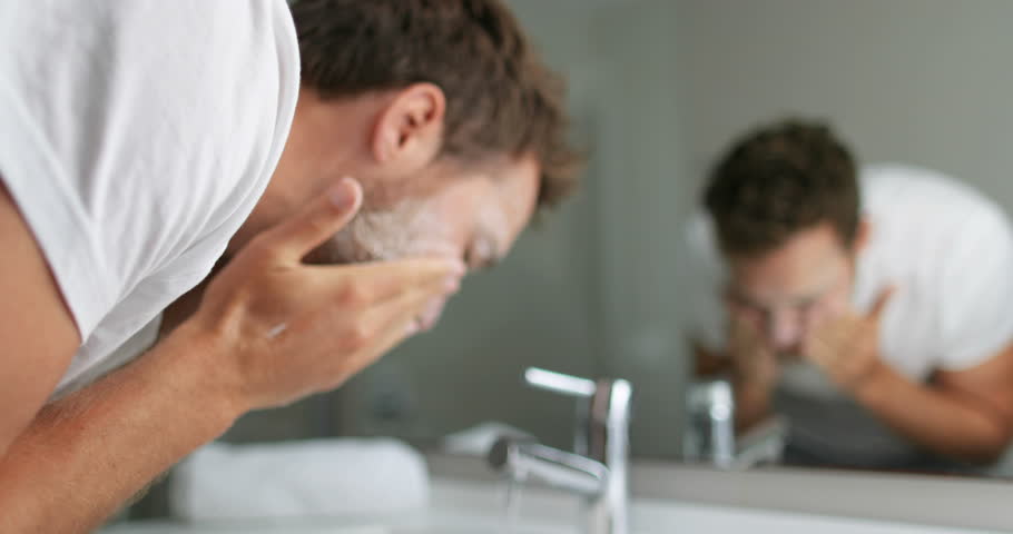 man washing face