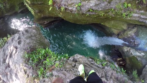 POV of man jumping into a pool beside a waterfall at Badian Cebu in the Philippines