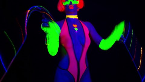 sexy female disco dancer poses in UV fluorescent costume