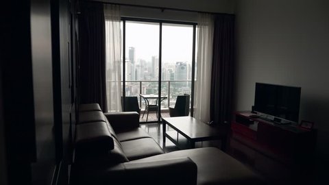 Luxury living room with terrace and view over cityscape. Luxury apartment, real estate concept.