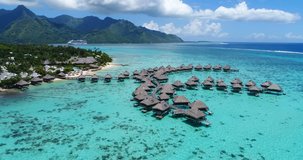 Luxury Resort Travel Vacation. Beautiful turquoise lagoon and the overwater bungalows. Amazing tropical beach and mountains in French Polynesia. Summer holiday concept. Aerial drone video