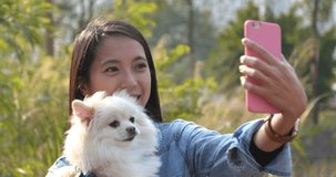 Woman taking selfie with her dog