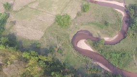 Aerial video of the stream in a shape of big snake on land at Aoral district in Kampong Speu province in Cambodia, Southeast Asia.