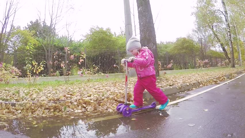 Young girl teaches a baby girl to ride on