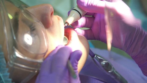 Dentist Cleans Teeth of Patient