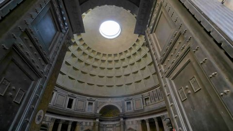 Rome, Italy Oct 8, 2017: Entrance door to pantheon view of pantheon ceiling spinning sun rays coming through the hole in Rome city italy.