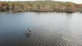 Couple Kayaking on a lake in the fall in New York State