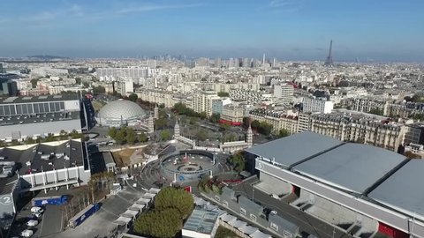 The city of Paris shot from the Paris Expo Porte de Versailles congress center / Paris drone footage on a clear blue sky / Eiffel Tower and Paris cityscape aerial footage.