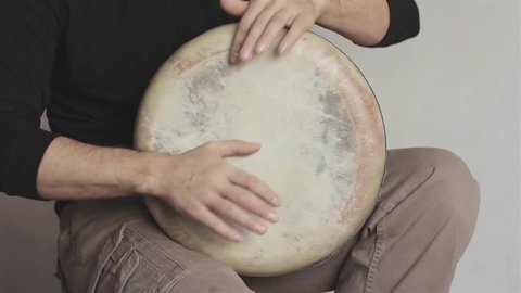 Man plays ethnic drum darbuka close up. Male hands tapping djembe bongo hands movement rhythm. Musical instruments world culture sound 