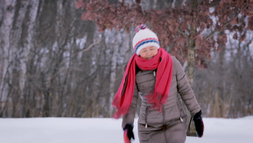 Asain woman freezing on a cold winter day.