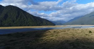 New Zealand nature landscape aerial drone video of Haast River by Mount Aspiring National Park, South Island, New Zealand.
