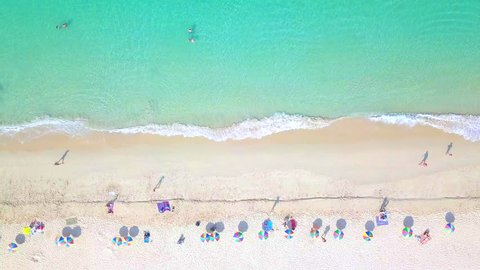 Aerial top view crowd people at Surin Beach in Phuket, Thailand, Southern beach of Thailand, Surin beach is very beautiful famous tourist destination in Andaman sea, Phuket, 4k aerial view beach.