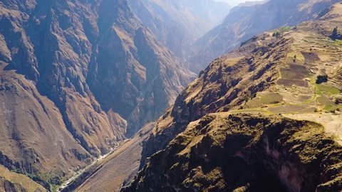 Drone aerial flying sideways over the massive Colca Canyon valley in Peru