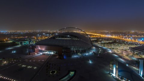 DOHA, QATAR - CIRCA JAN 2018: Aerial view of Aspire Zone from top night to day timelapse in Doha. Traffic on the road. Foggy weather