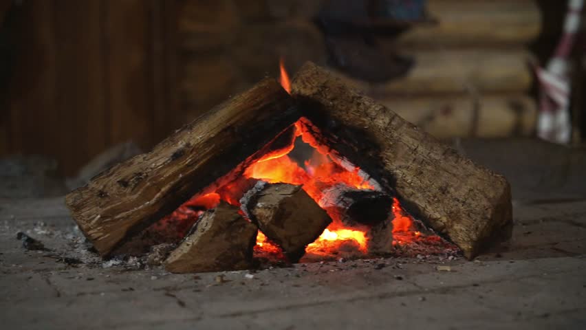 Hot fireplace full of wood and fire burning