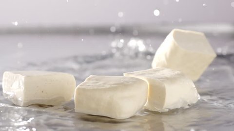 
slow motion tofu falling and water splash out
