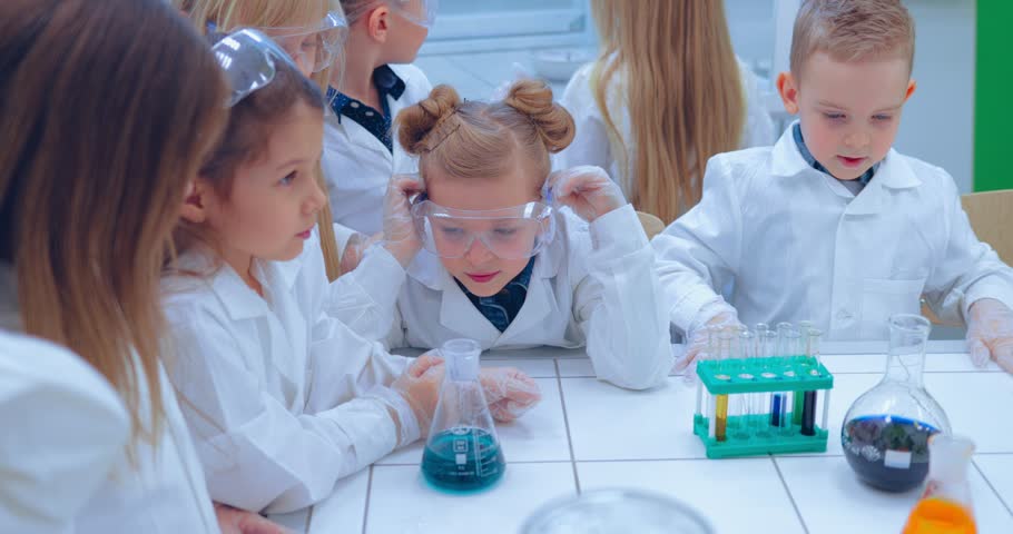 Elementary school chemistry class - chemistry experiments. Children studing chemistry in school laboratory