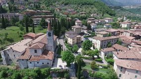 Italy. Church on the mountain and the old town. Panorama of the gorgeous Lake Garda surrounded by mountains. video shooting with drone