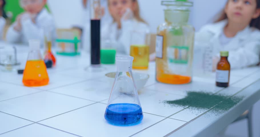 Elementary school chemistry class - chemistry experiments. Children studing chemistry in school laboratory