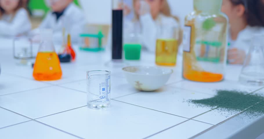 Children studing chemistry in school laboratory. Children in chemistry class