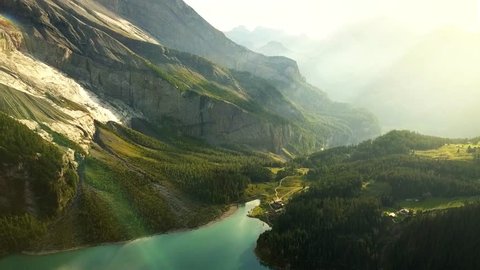 Aerial view of a beautiful mountain lake and landscape bathed in evening light in Switzerland