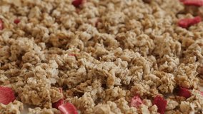 Tilting over muesli with strawberry flavour close-up 4K 2160p 30fps UltraHD footage - Healthy dehydrated  crunchy cereals slow tilt 3840X2160 UHD video