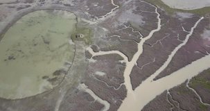 Drone video of a delta where the river flows into the sea with multiple branches