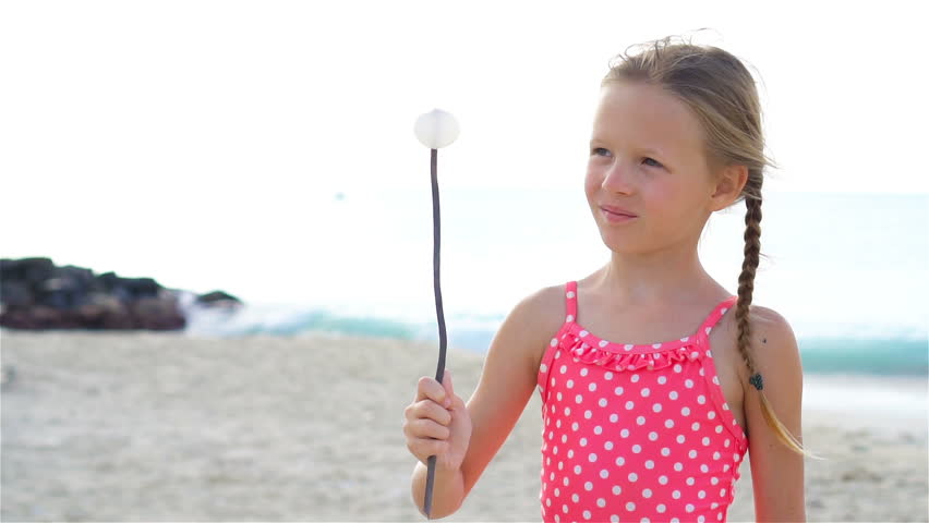 Adorable active little girl at beach during summer vacation