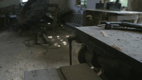 Dusty cluttered work surface, workbench in the workshop. Old machine
