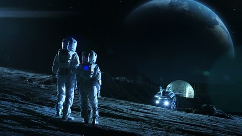 Two Astronauts in Space Suits Stand on the Moon Looking at the Beautiful Earth. In the Background Lunar Base with Geodesic Dome. Moon Colonization and Space Travel Concept. Establishing Shot.