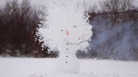 Smoke fly from snowman head, then it explode and fly apart, only body balls stay at place. Overwork and stress concept, hard winter season time, slow motion shot of blowing up snow sculpture