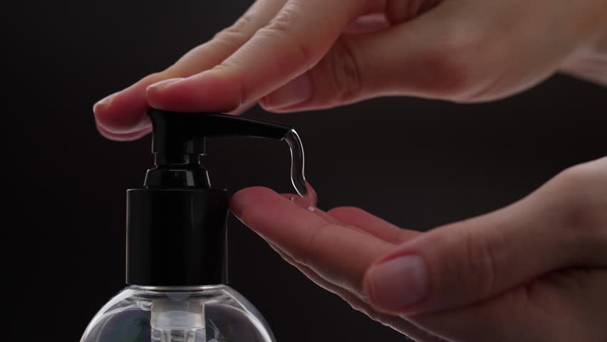 Girl washing hands in bathroom, push soap bottle pump, liquid squeeze out on palm, closeup shot against black background. Soft silky detergent for skin care and protection | Shutterstock HD Video #1007758900