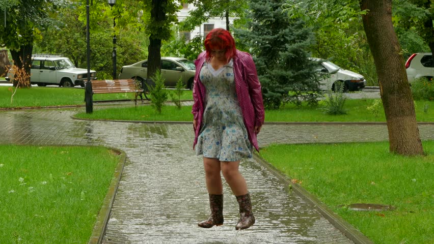 Thick girl jumping in a puddle