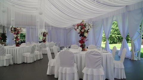 Interior of a wedding hall decoration ready for guests.Beautiful room for ceremonies and weddings.Wedding concept.Luxury stylish wedding reception purple decorations expensive hall.Wedding decor