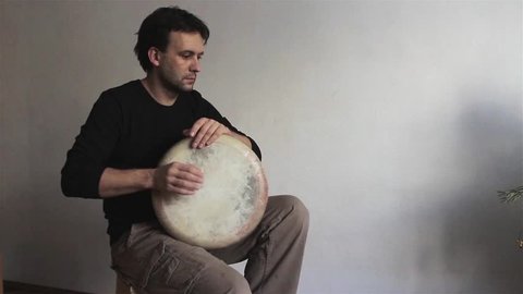 Man musician plays ethnic drum darbuka close up indoors. Male hands tapping djembe bongo hands movement rhythm. Musical instruments handmade world culture sound