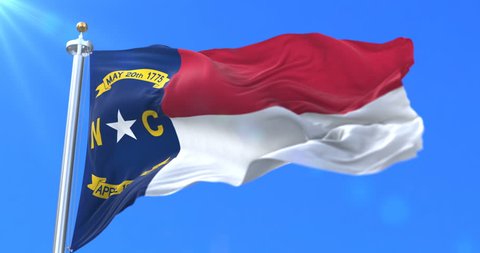 Flag of american state of North Carolina, region of the United States, waving at wind - loop