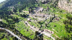 Aerial bird's eye view video taken by drone of archaeological site of ancient Delphi, site of temple of Apollo and the Oracle, Voiotia, Greece