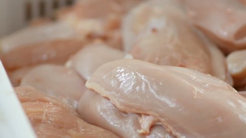 Food processing plant, chicken fillet close up in box